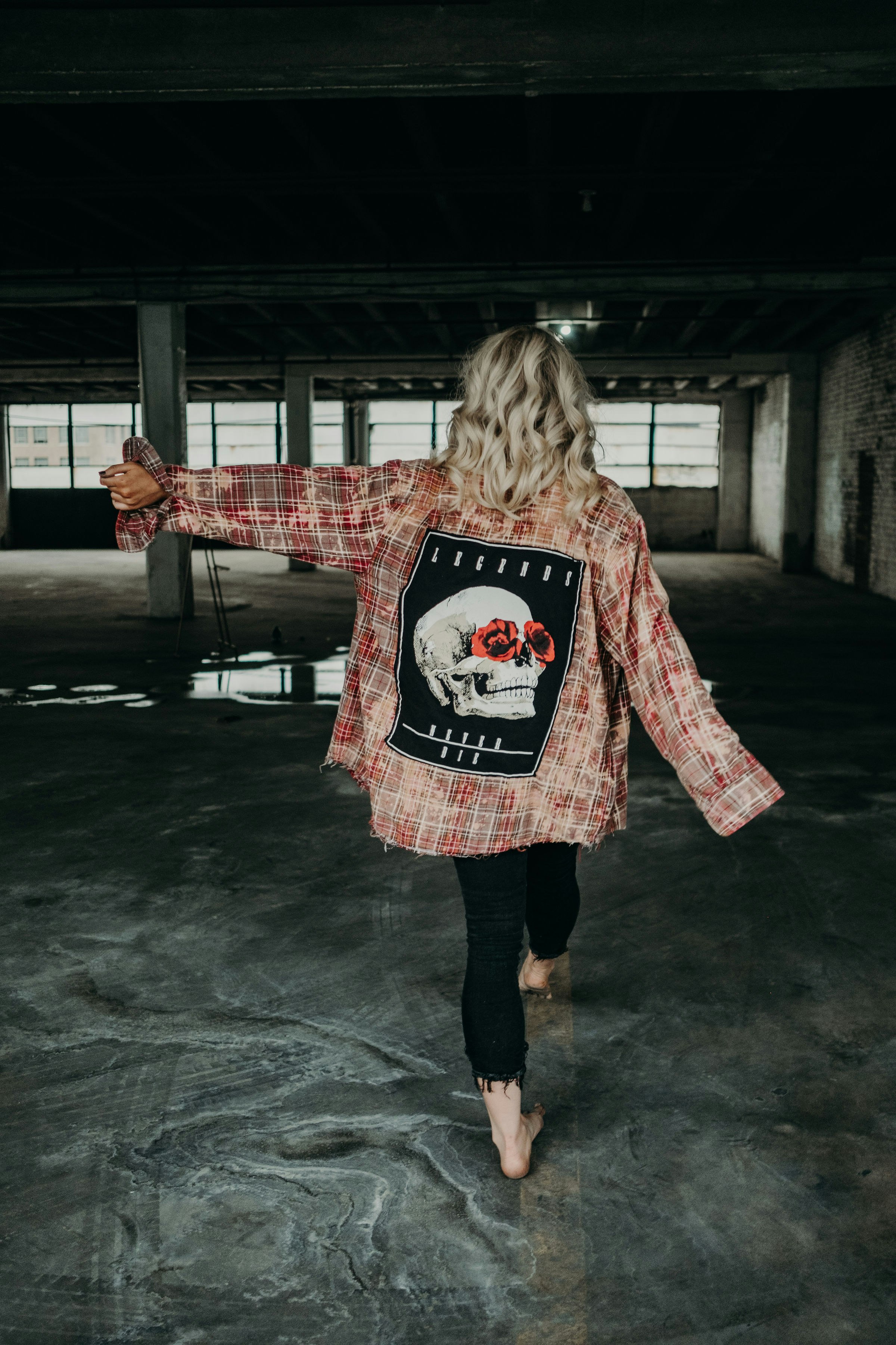 girl in red and white sweater standing on gray concrete floor